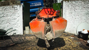grab lorry bucket dropping walling stone